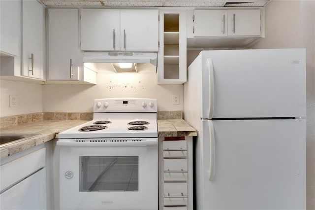 kitchen featuring white cabinets and white appliances