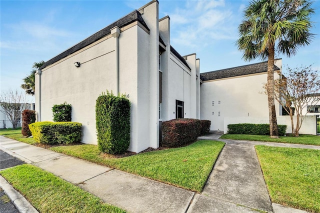 view of property exterior with a lawn