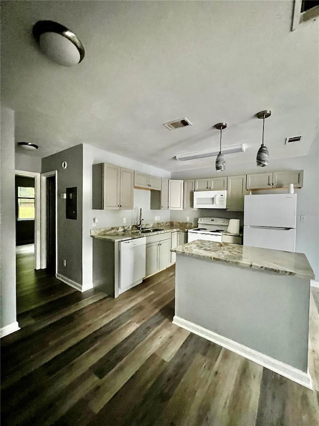 kitchen with pendant lighting, dark hardwood / wood-style flooring, white appliances, and sink