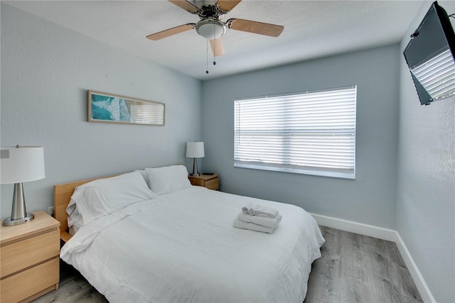 12321 Gulf Blvd, Treasure Island, FL 33706 - bedroom with wood finished floors, baseboards, and ceiling fan