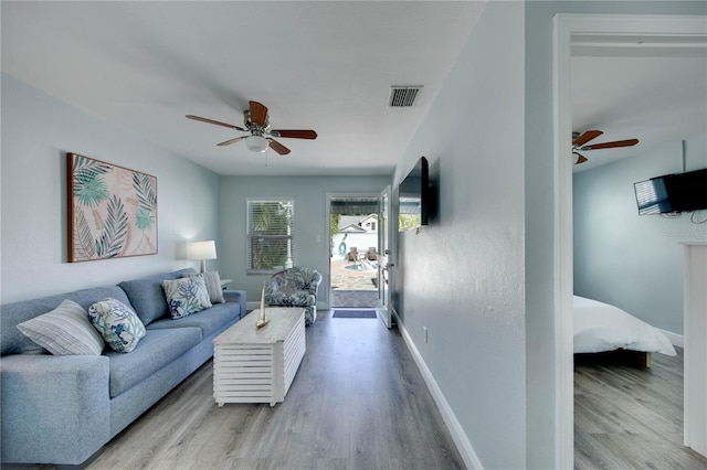 12321 Gulf Blvd, Treasure Island, FL 33706 - living area with ceiling fan, wood finished floors, and baseboards