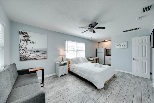 12321 Gulf Blvd, Treasure Island, FL 33706 - bedroom with freestanding refrigerator, wood tiled floors, baseboards, and ceiling fan