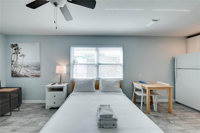 12321 Gulf Blvd, Treasure Island, FL 33706 - bedroom with freestanding refrigerator, ceiling fan, and baseboards