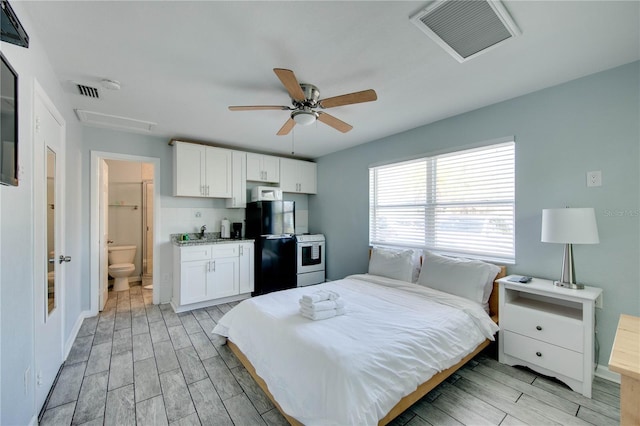 12321 Gulf Blvd, Treasure Island, FL 33706 - bedroom featuring wood finish floors, freestanding refrigerator, and ceiling fan