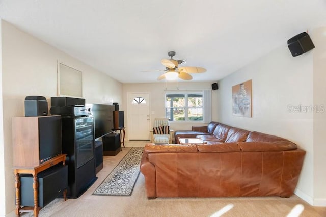 carpeted living room featuring ceiling fan