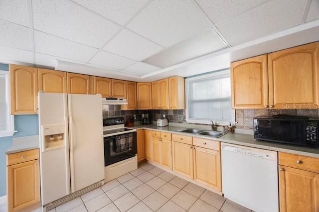 kitchen featuring backsplash, a paneled ceiling, white appliances, sink, and light tile patterned floors