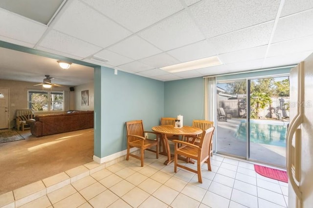 dining area featuring a wealth of natural light, a drop ceiling, and ceiling fan