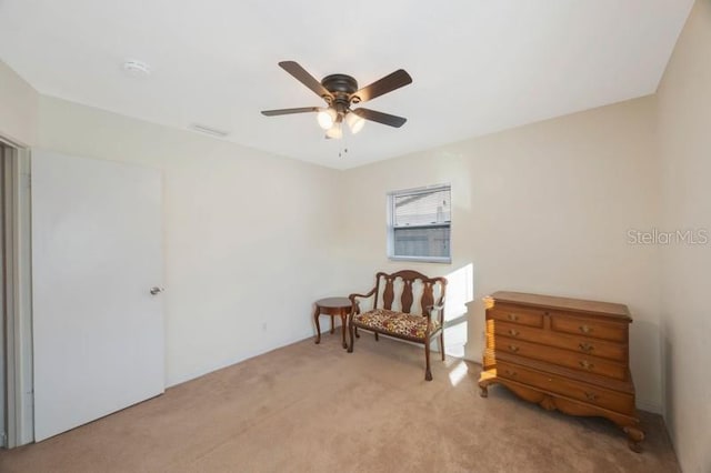 sitting room with light carpet and ceiling fan