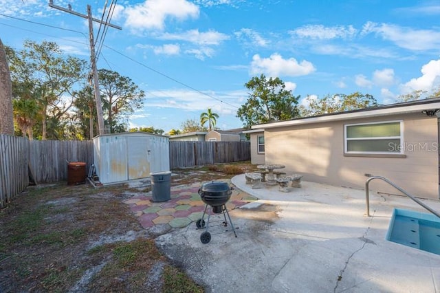 view of patio featuring a storage shed