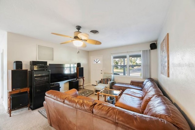 carpeted living room featuring ceiling fan