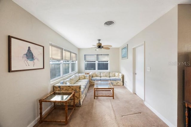 carpeted living room featuring ceiling fan