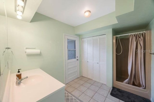 bathroom featuring tile patterned floors, sink, and walk in shower