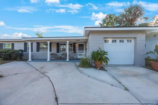 ranch-style house featuring a porch and a garage