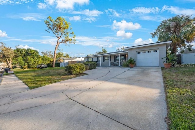 ranch-style home with a garage and a front lawn