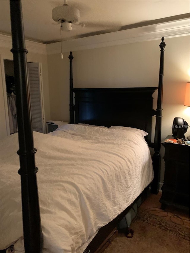 bedroom featuring carpet flooring, ceiling fan, and crown molding