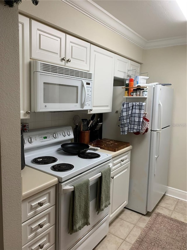 kitchen with white cabinetry, backsplash, white appliances, light tile patterned floors, and ornamental molding