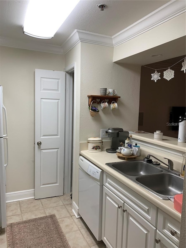 kitchen with white cabinets, crown molding, sink, light tile patterned floors, and dishwasher