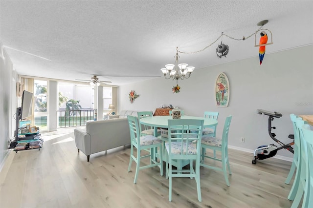 dining room featuring ceiling fan with notable chandelier, a textured ceiling, and light hardwood / wood-style flooring