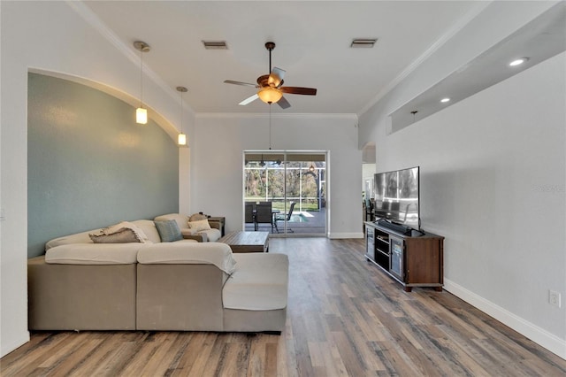 living room with crown molding, hardwood / wood-style floors, and ceiling fan