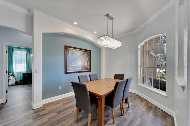 dining space featuring hardwood / wood-style floors, plenty of natural light, and ornamental molding