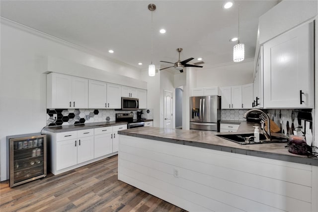 kitchen with white cabinets, wine cooler, and appliances with stainless steel finishes