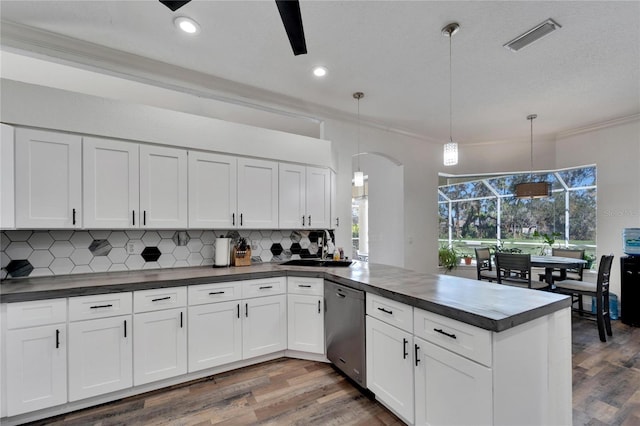 kitchen with dishwasher, white cabinets, a healthy amount of sunlight, and decorative light fixtures