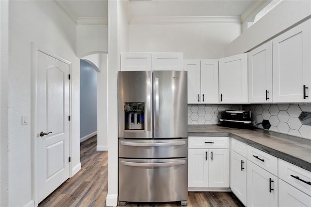 kitchen with stainless steel fridge with ice dispenser, dark hardwood / wood-style flooring, decorative backsplash, white cabinets, and ornamental molding