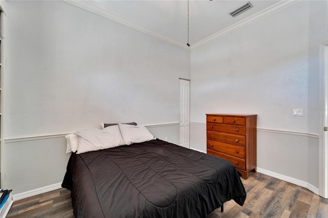 bedroom with ornamental molding and dark wood-type flooring