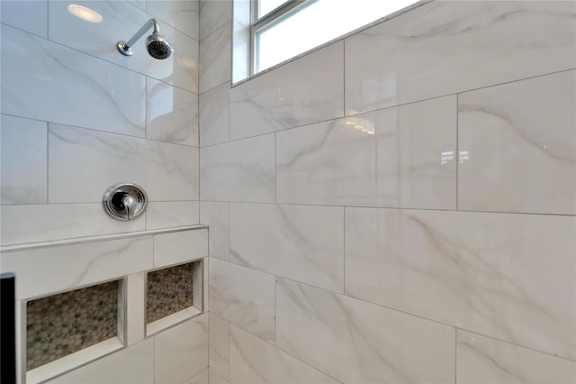 bathroom with a tile shower