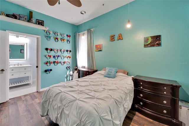 bedroom with hardwood / wood-style floors, ensuite bath, ceiling fan, and sink