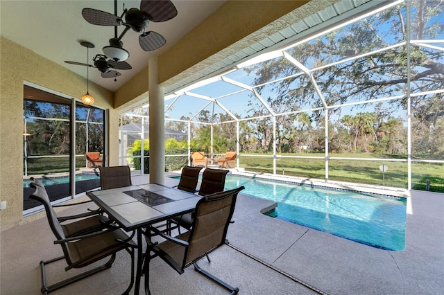 view of pool with ceiling fan, a patio area, and a lanai