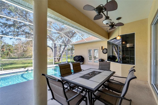 sunroom / solarium with a wealth of natural light, a swimming pool, and ceiling fan