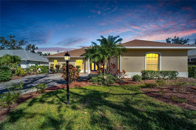 ranch-style house with a lawn