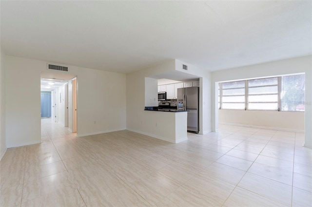 unfurnished living room with light tile patterned floors