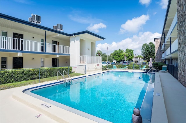 view of swimming pool with central AC unit