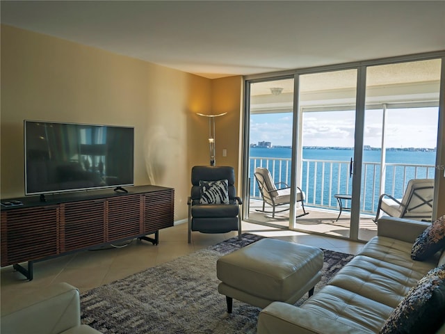 living room with a water view, a wall of windows, and light tile patterned flooring