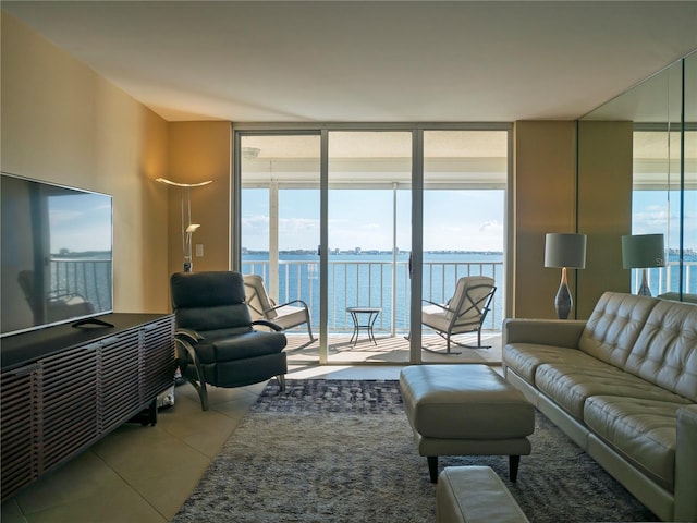 living room with floor to ceiling windows, a wealth of natural light, and a water view