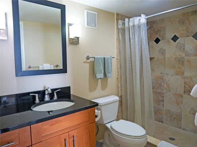 bathroom with walk in shower, vanity, and toilet