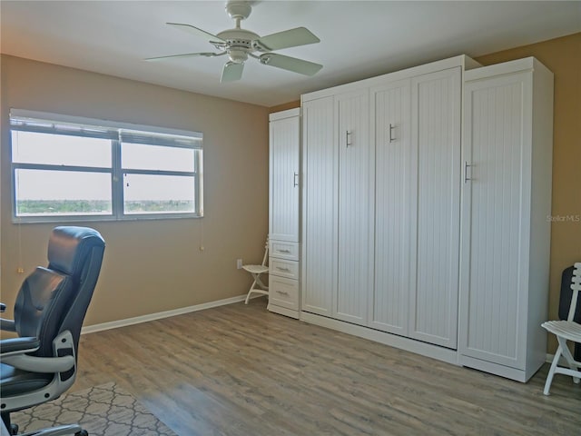 home office featuring ceiling fan and light hardwood / wood-style flooring