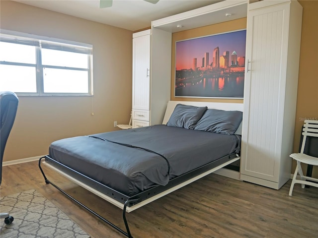 bedroom featuring ceiling fan and dark hardwood / wood-style flooring