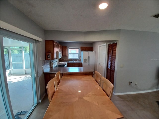 tiled dining area featuring sink