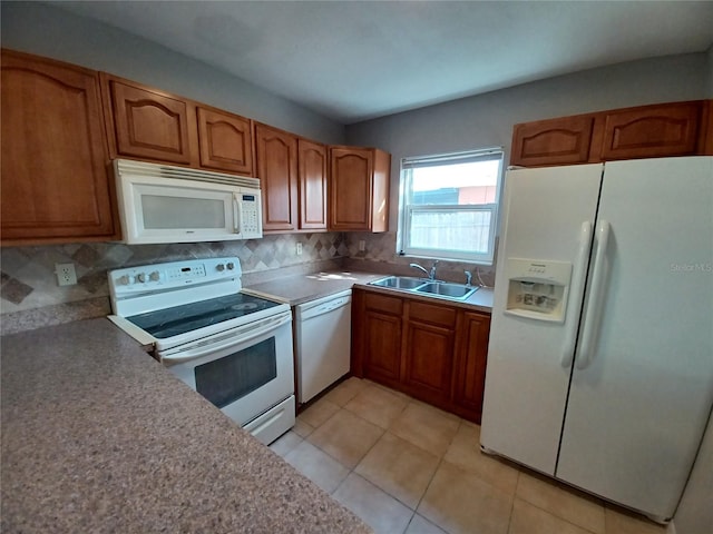 kitchen with sink, light tile patterned floors, white appliances, and decorative backsplash