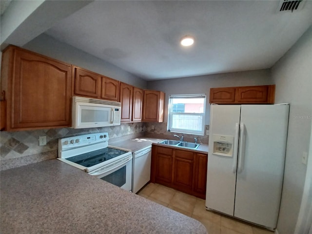 kitchen featuring white appliances, light tile patterned floors, sink, and backsplash