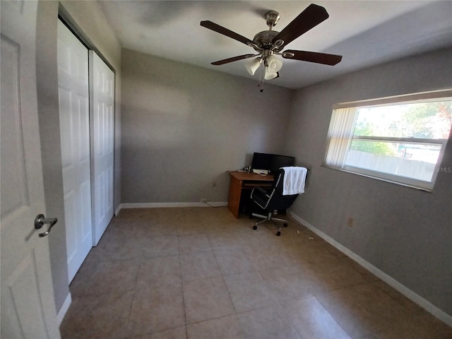 unfurnished office with light tile patterned flooring and ceiling fan