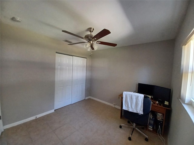 unfurnished office featuring ceiling fan