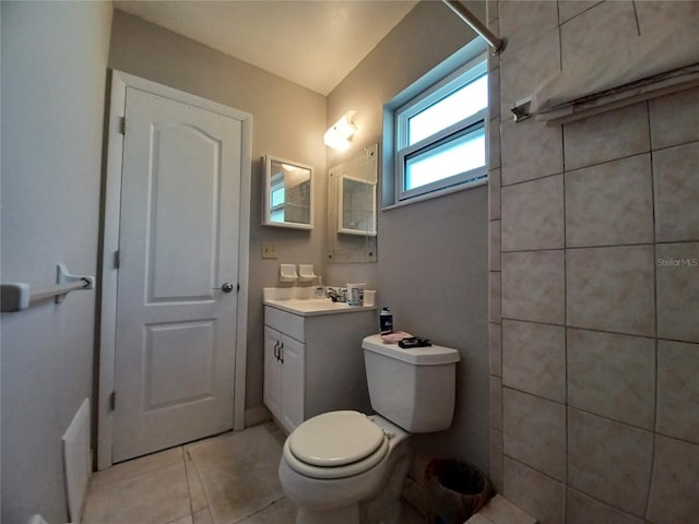 bathroom featuring vanity, tile patterned floors, and toilet