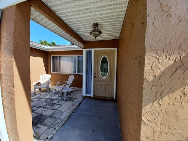 property entrance featuring a patio area