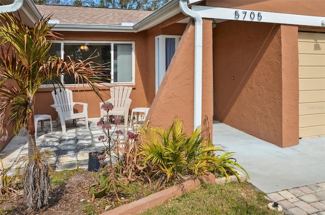 view of exterior entry featuring a patio area