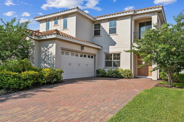 mediterranean / spanish-style house featuring a garage