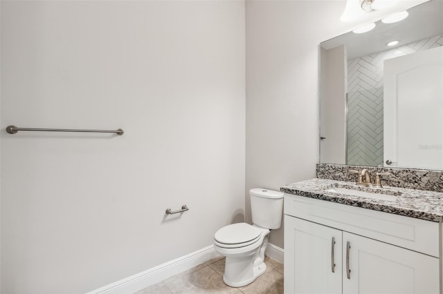 bathroom with tile patterned flooring, vanity, and toilet